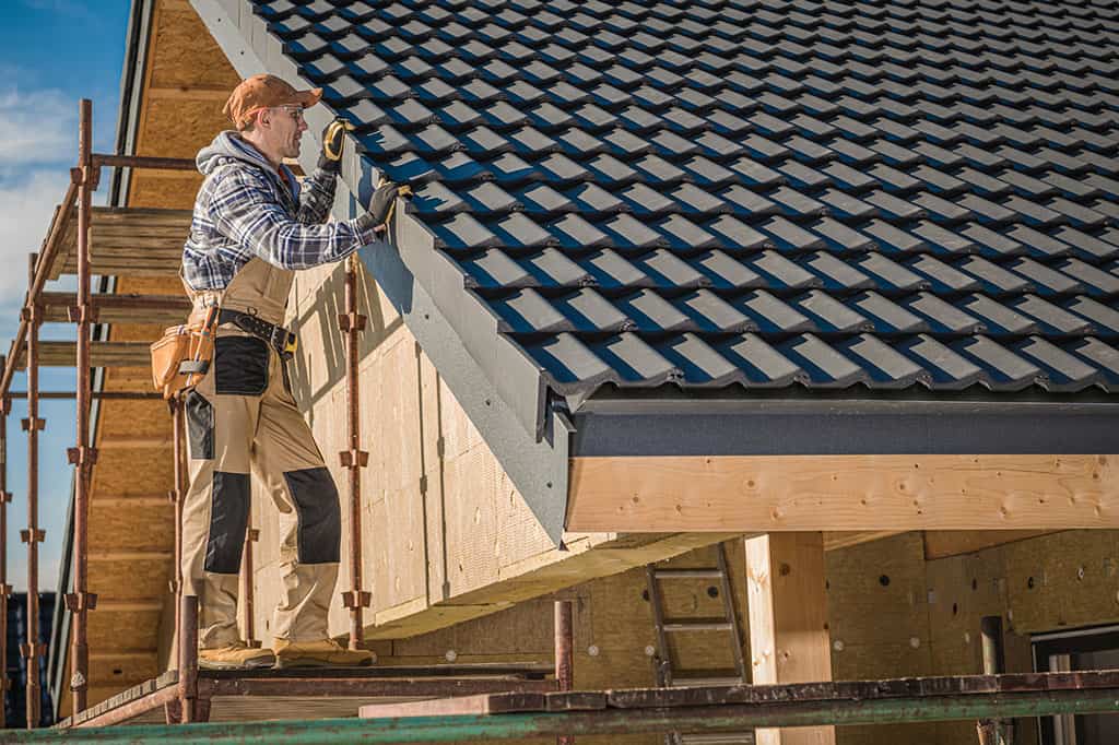 Roof installation being performed by a construction worker