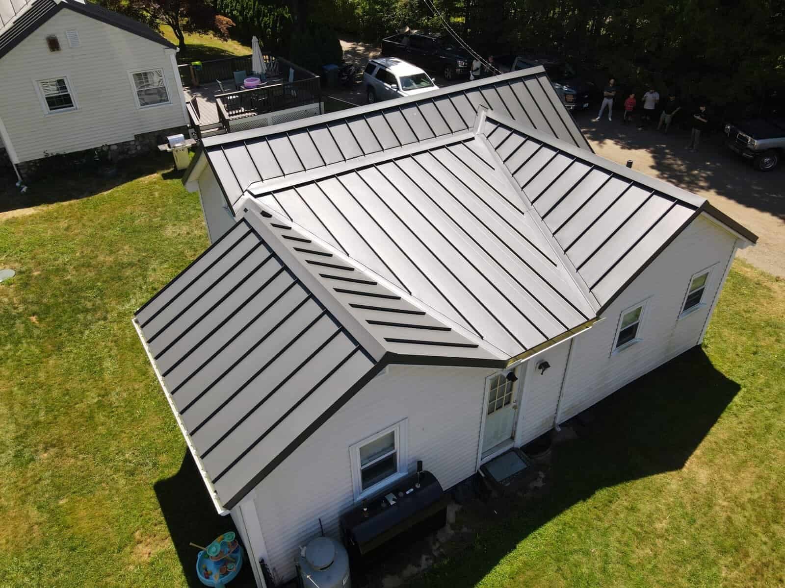 Metal flashing and pipe boot installation on roof