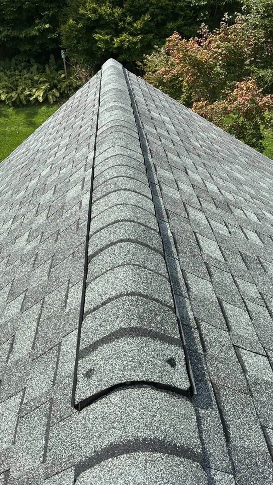 Close-up of a new ridge vent with cap shingles on a Ridgefield, CT roof