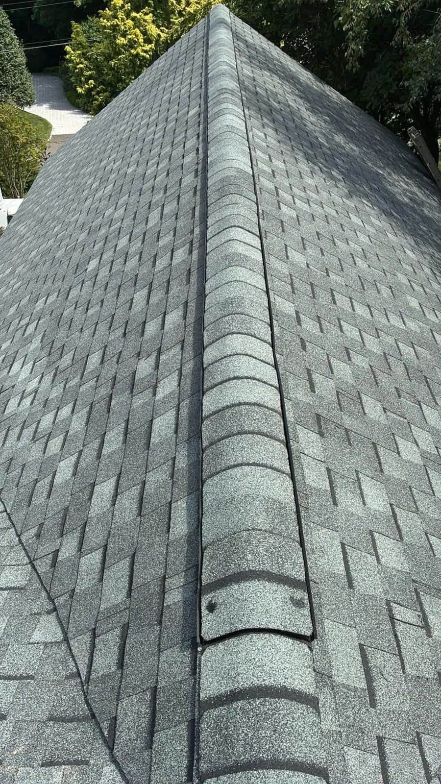 View along the ridge of a new gray shingle roof in Ridgefield, CT
