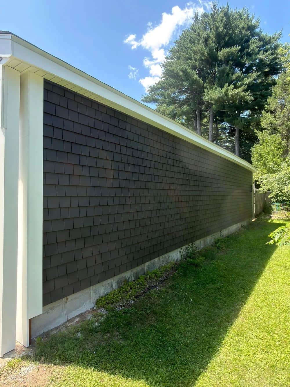 Close-up of new dark gray shake-style siding on a Turners Falls, MA home
