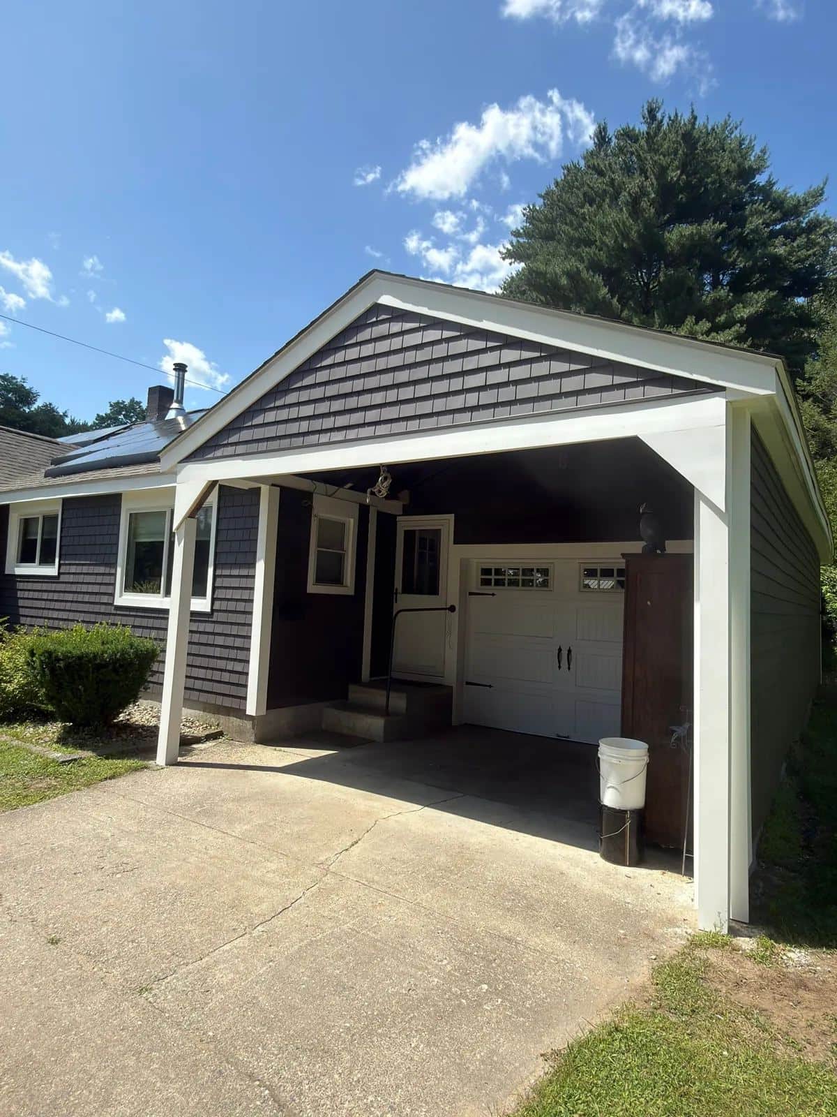 Garage of a Turners Falls, MA home with new dark gray shake-style siding
