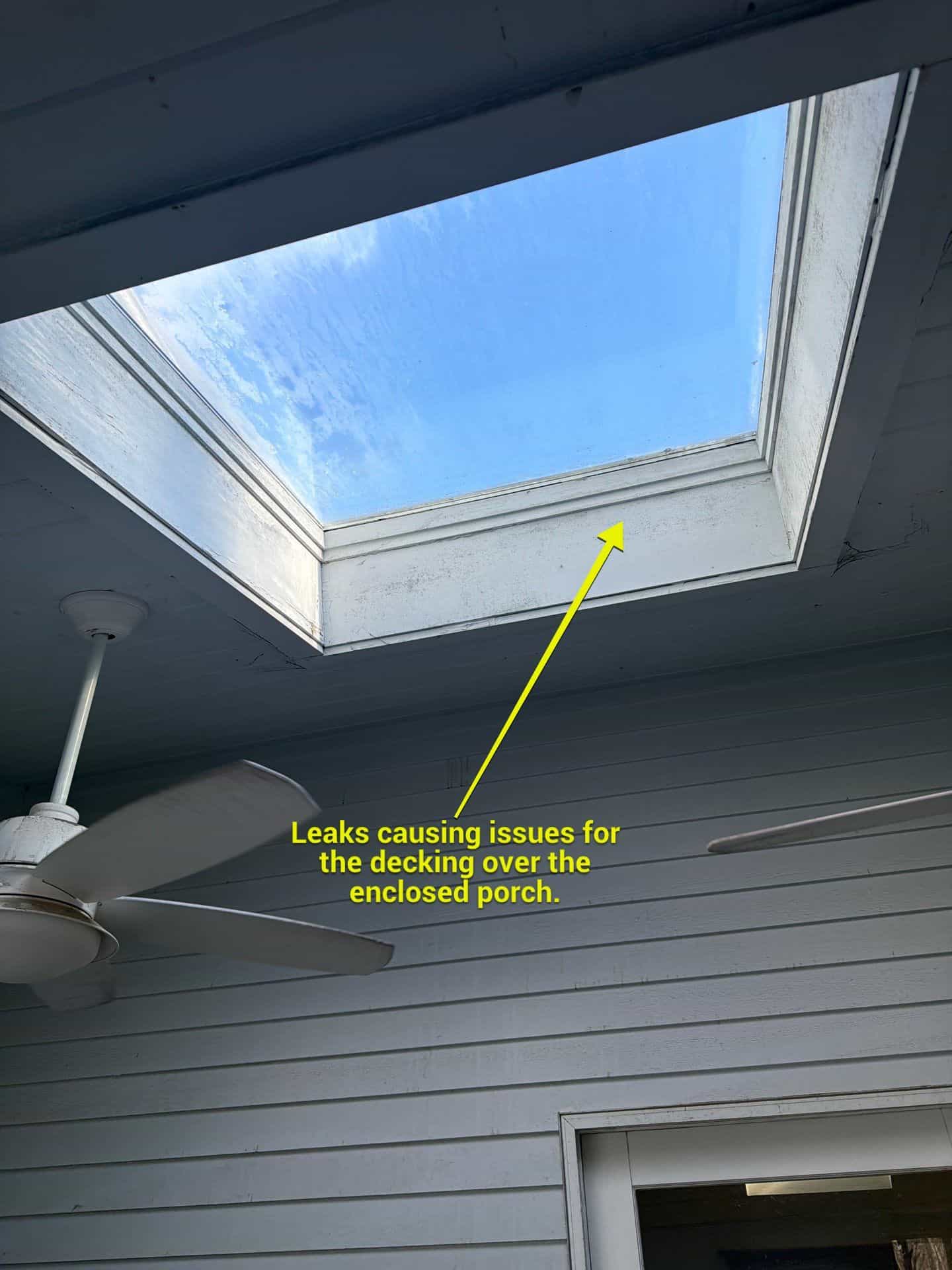 Annotated 360° Roof Report photo showing a skylight leaking onto the enclosed porch decking