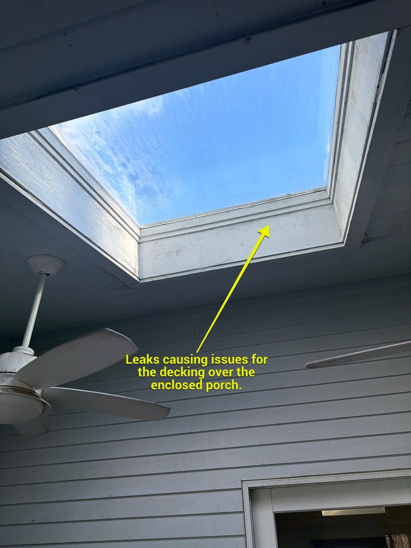 Annotated 360° Roof Report photo showing a skylight leaking onto the enclosed porch decking