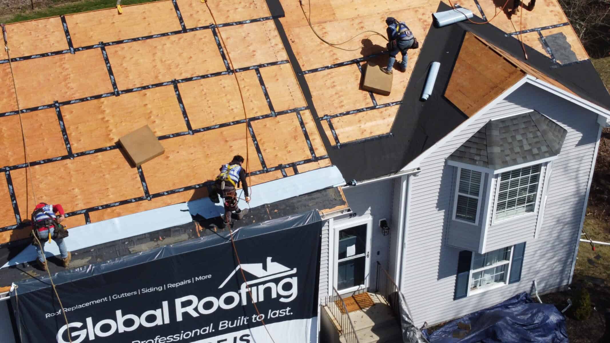 Aerial view of Global Roofing crew performing a roof inspection