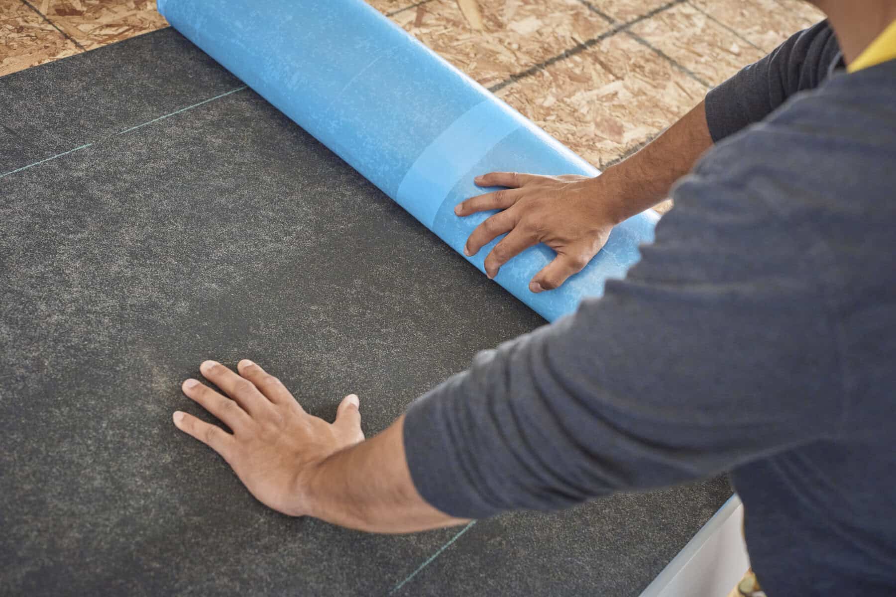 WinterGuard waterproofing underlayment being installed on a Danbury roof deck