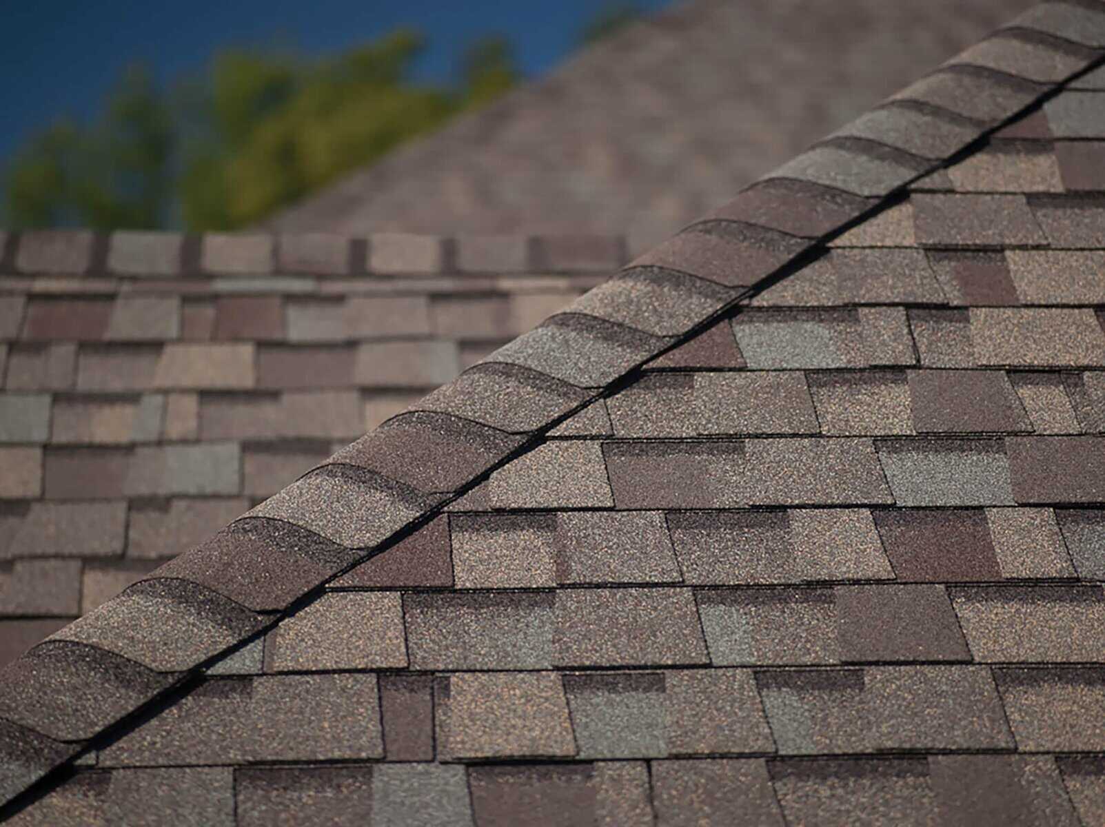 Hip and ridge cap shingles installed on roof peak