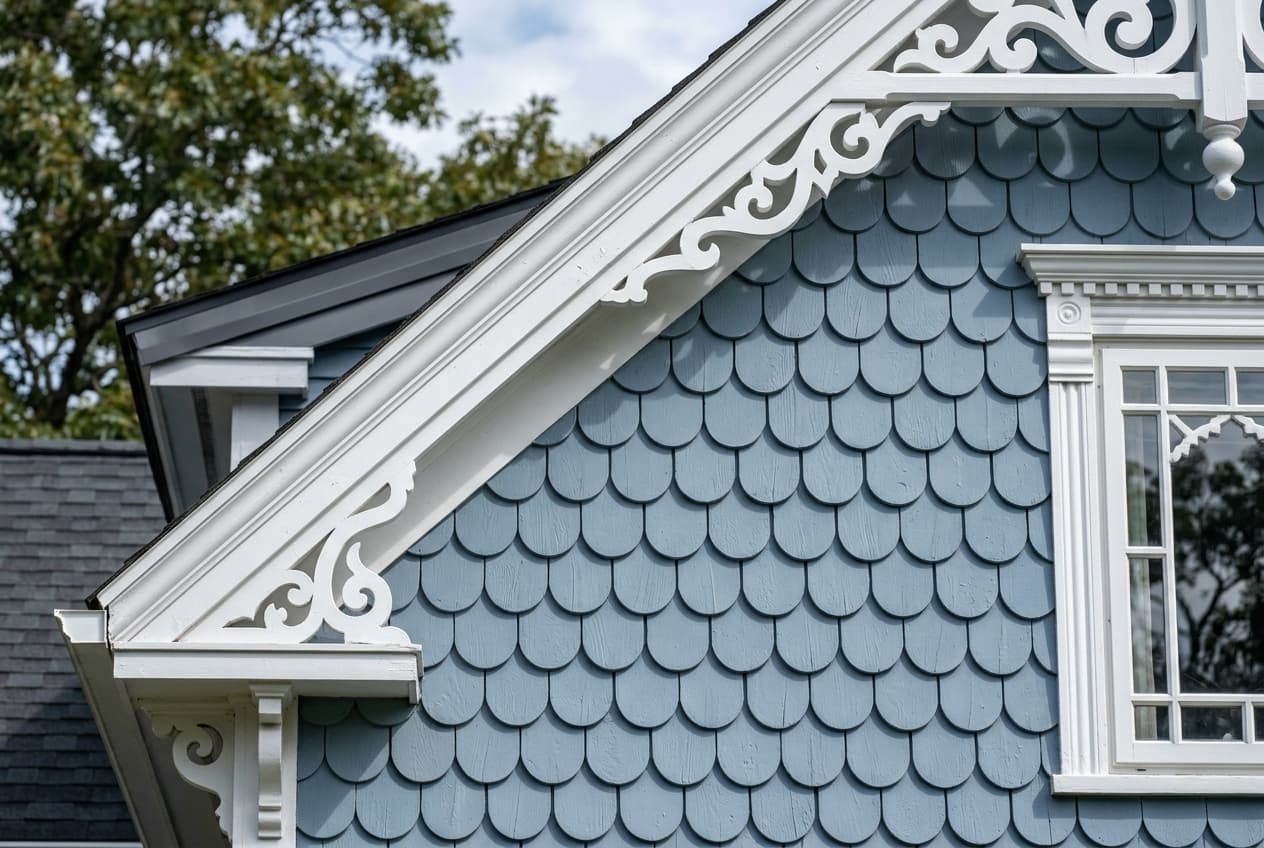 Soft blue half-round scallop shingle siding on a Victorian gable