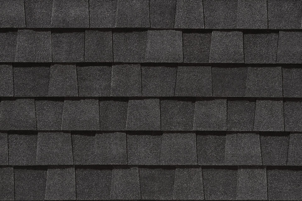 Black Certainteed asphalt shingle roof with layered texture and precise alignment, showcasing durable roofing material for residential or commercial buildings.