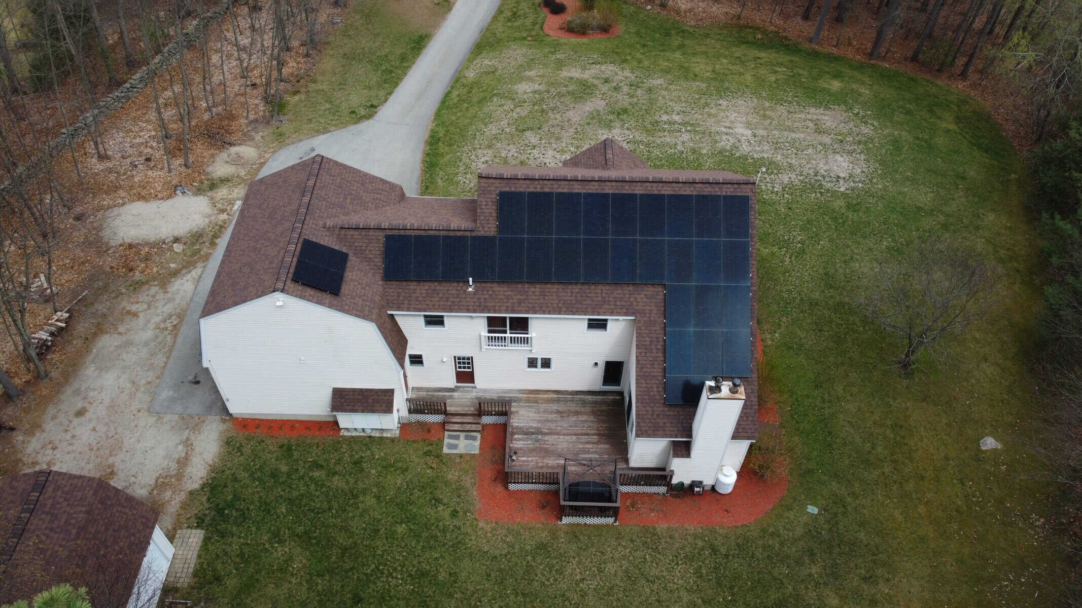 Solar roof installation with durable Certainteed shingles and advanced underlayment for New England climates, featuring solar panels on a residential home.