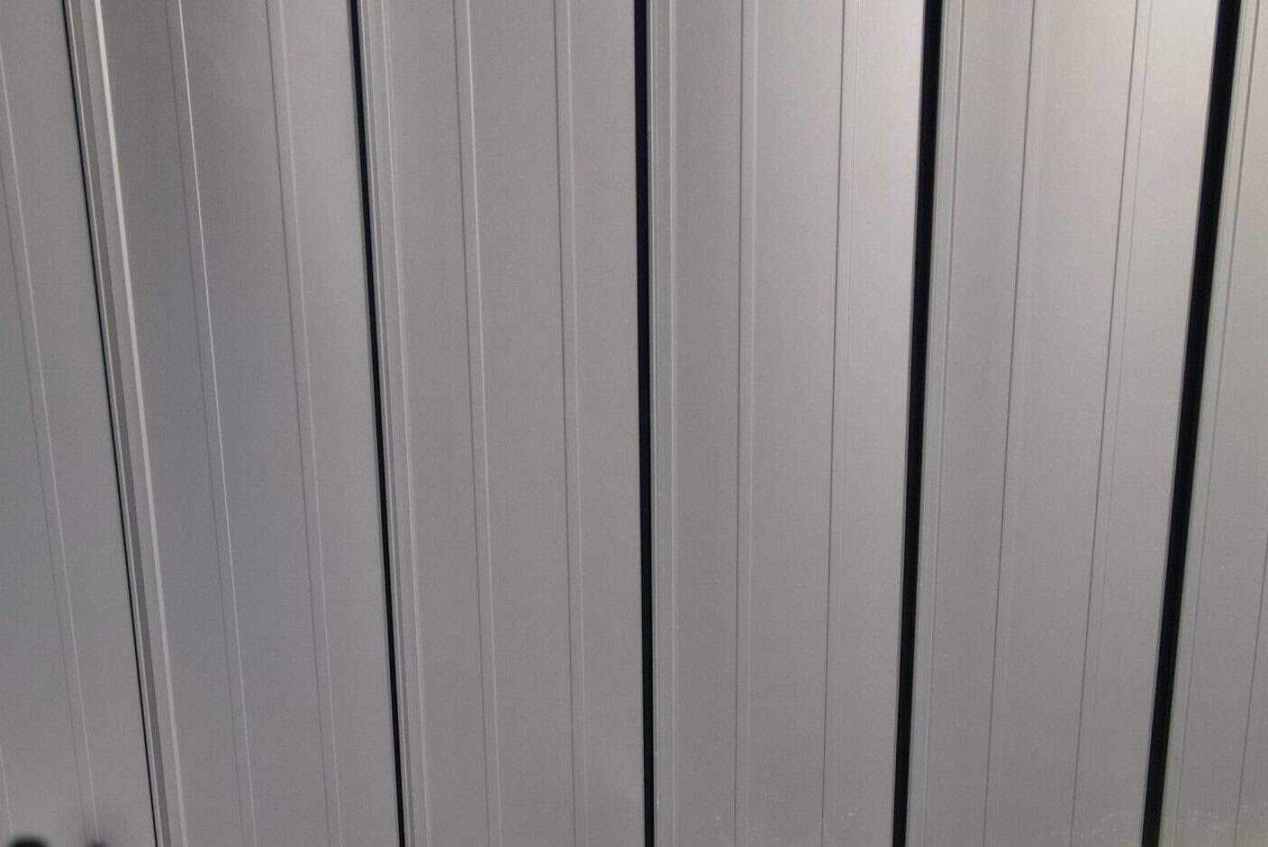 Metal roof with vertical panels for durable exterior protection.